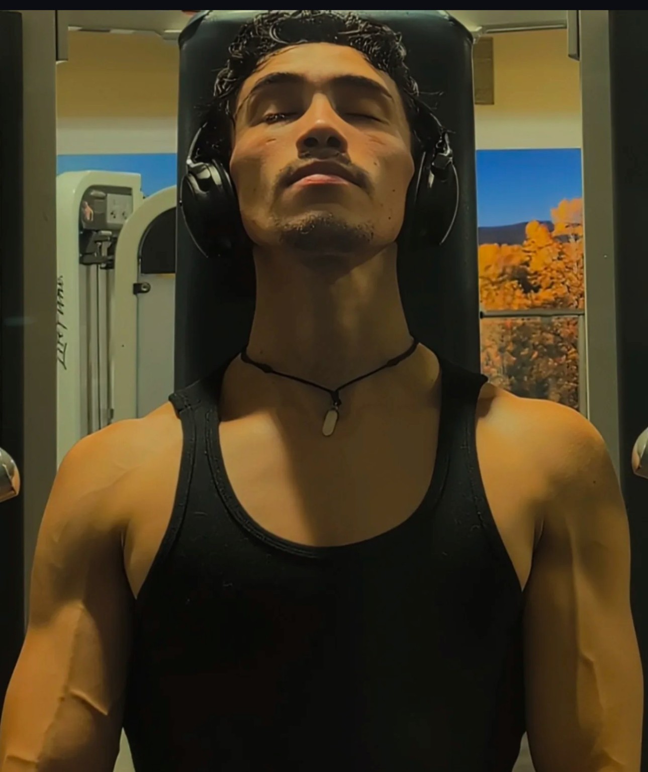 Giancarloue at the gym wearing headphones.