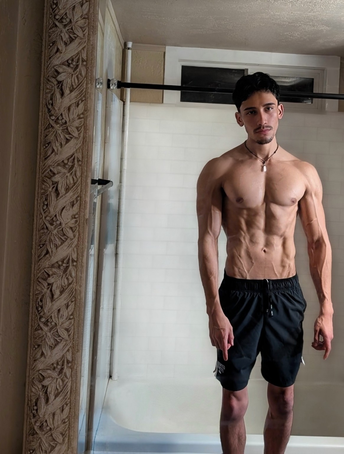 Giancarloue standing in black training shorts.